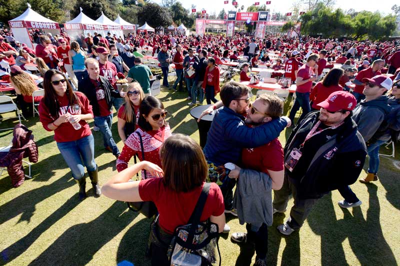 Two people greet with a hug in the crowd