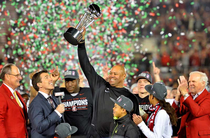 Coach Shaw holding the Rose Bowl trophy