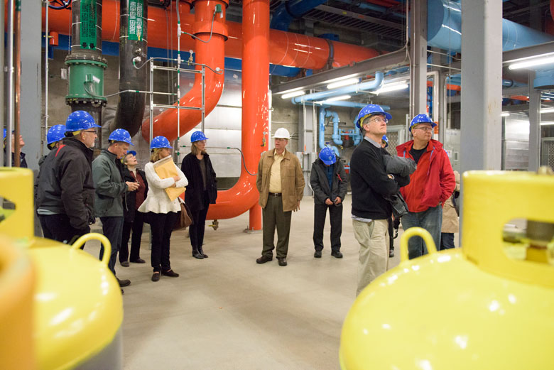 Members of the Faculty Senate in hard hats walking through the facility