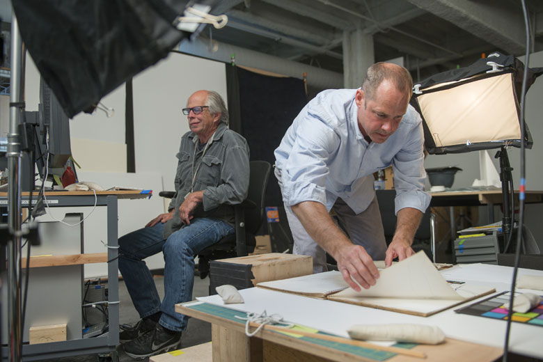 Photographer Lee Fatheree, left, and Digitization Project Coordinator Colin Stinson work on photographing the sketchbooks of Robert Diebenkorn at Stanford's Cantor Arts Center