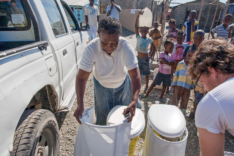 Residents of Cap Haitien, Haiti, receive portable dry household toilets