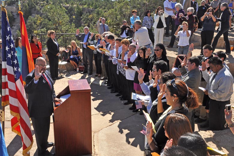 People being sworn in as U.S. citizens in an outdoor amphitheater