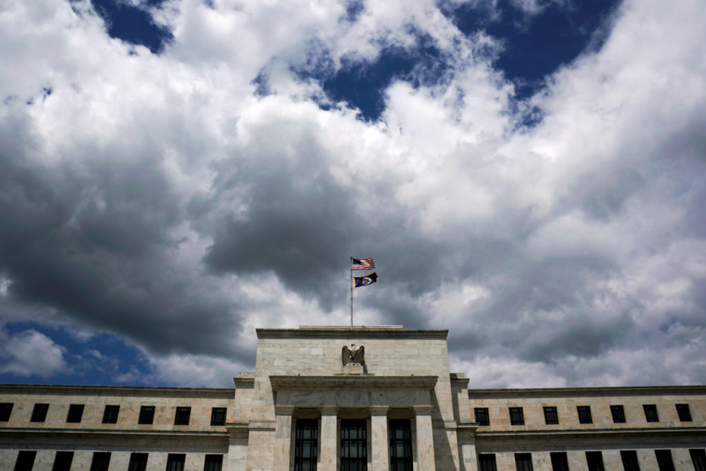 Flags fly over the Federal Reserve Headquarters in Washington