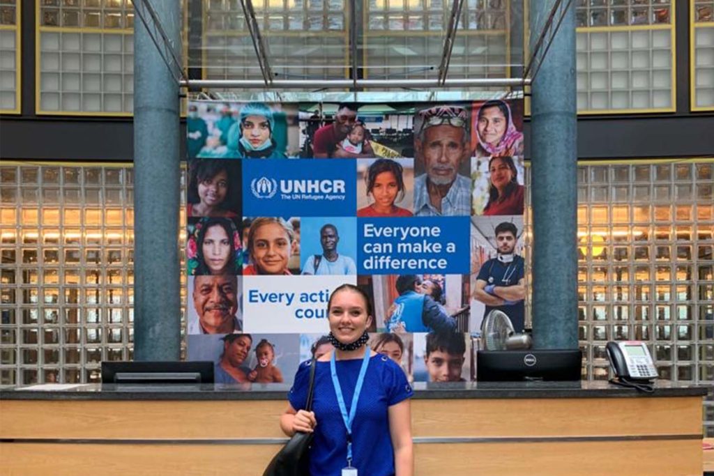 Stanford senior Eva Hangartner in from of a UNHCR banner