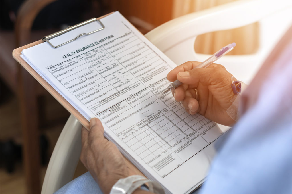 Health insurance claim form application for patient with illness in hospital ward.