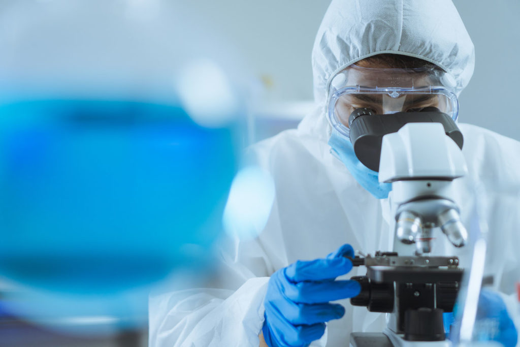 Lab researcher looking into a microscope