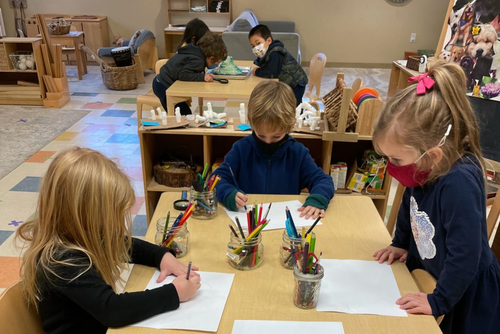 students in classroom wearing a mask