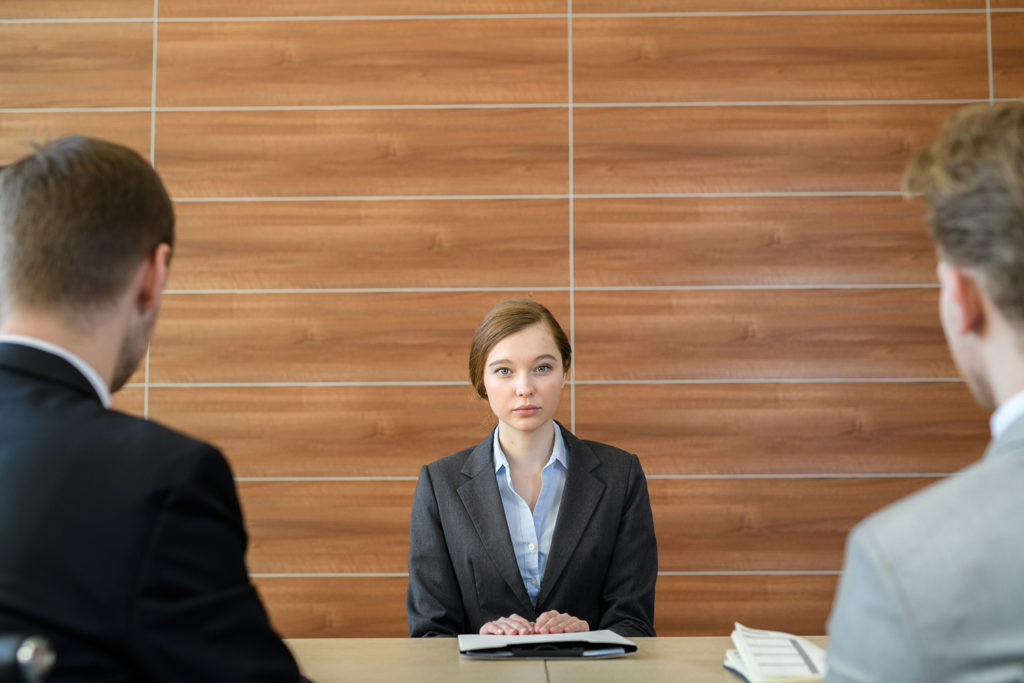 Woman in a business meeting with two men.