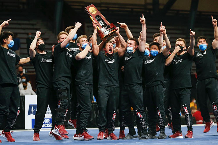 Cheering men holding trophy