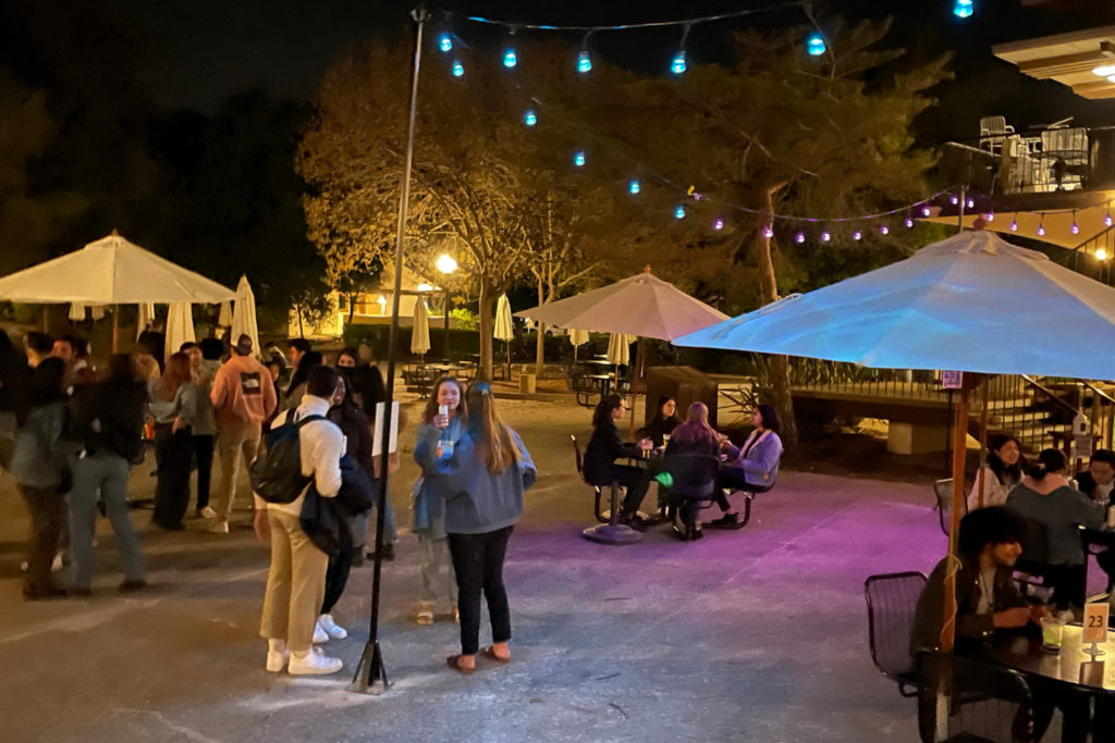 Students standing together under string lights