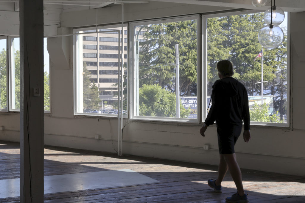 A man walks through empty office space in Seattle.