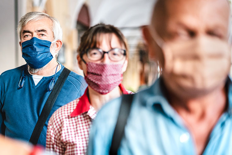 Crowd of adults wearing face coverings