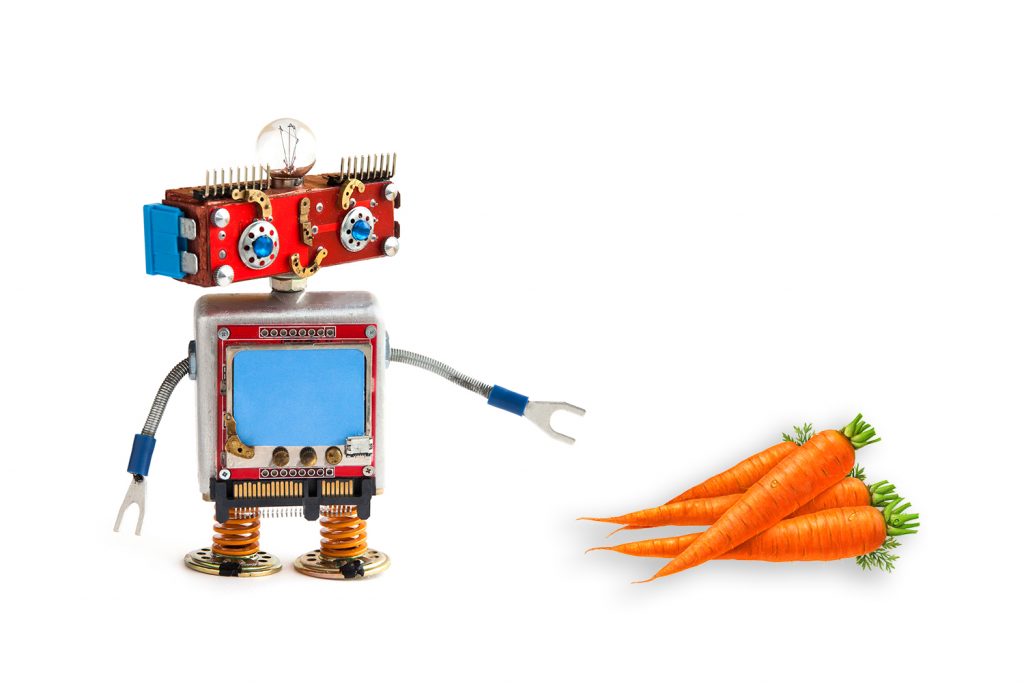 A photo illustration of a robot reaching for carrots.