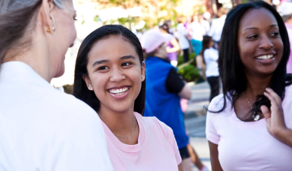 Women talking an an outdoor event. Credit: iStock/SDI Productions