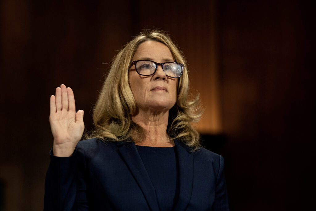 Christine Blasey Ford swears in at a Senate Judiciary Committee hearing for her to testify about sexual assault allegations against Supreme Court nominee Judge Brett M. Kavanaugh.