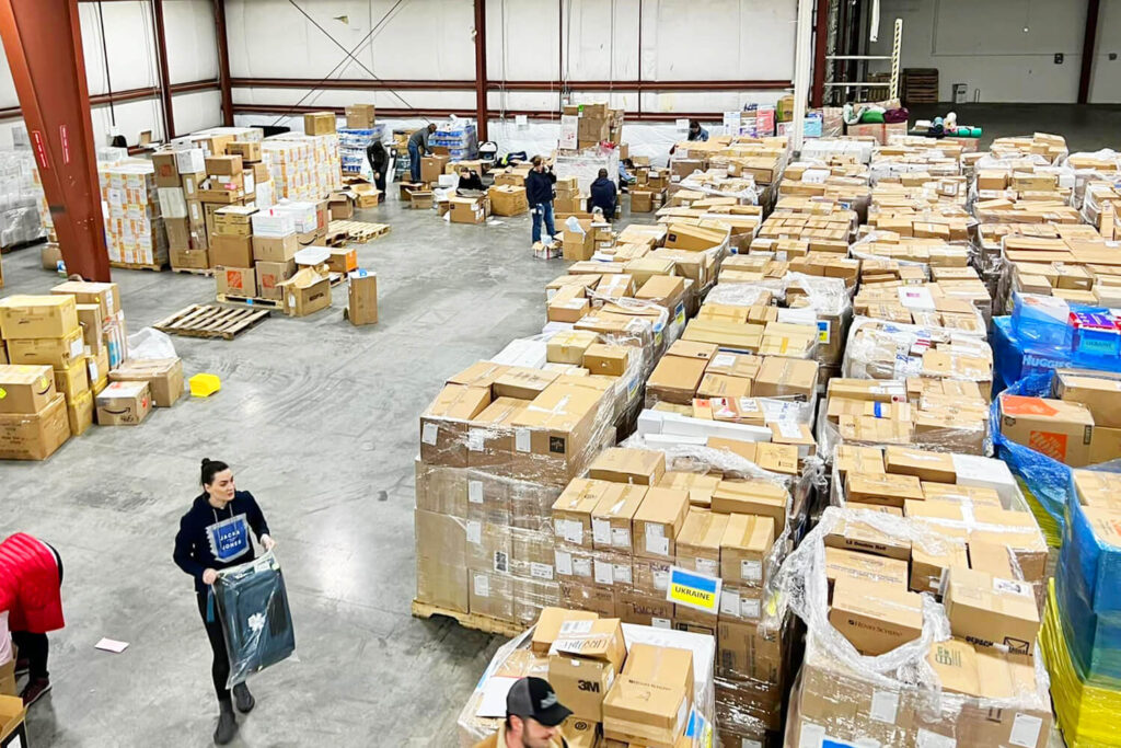 Students work in a warehouse preparing medical supplies to send to Ukraine.