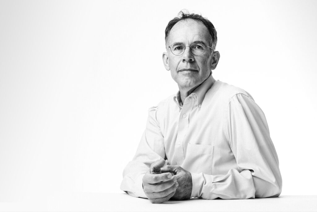 A black and white photograph of Guido Imbens, the Applied Econometrics Professor and Professor of Economics at Stanford GSB.