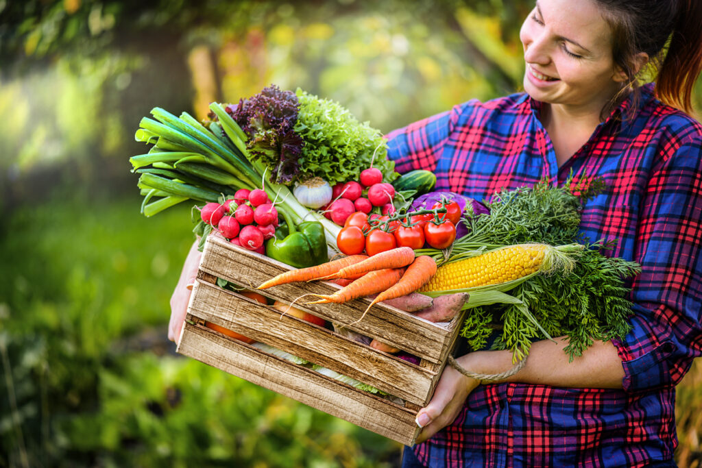 Woman holding a basket of vegetables