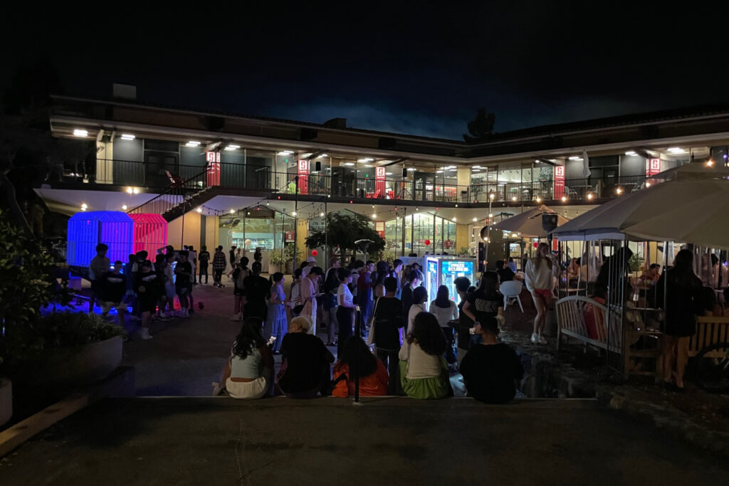 After dark at Tresidder, with bright lights from arcade games and crowd of students