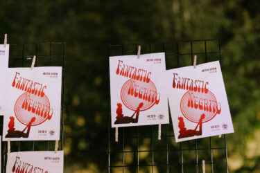 Recently printed posters drying on a clothes line