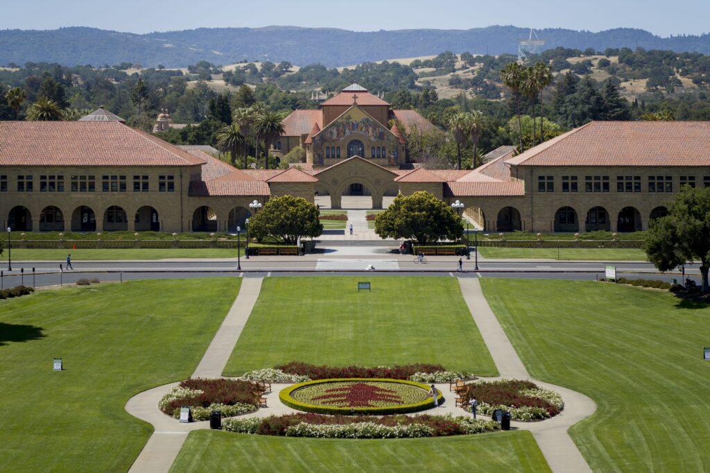 Looking past the green grass of the Oval at the front of Stanford's campus.