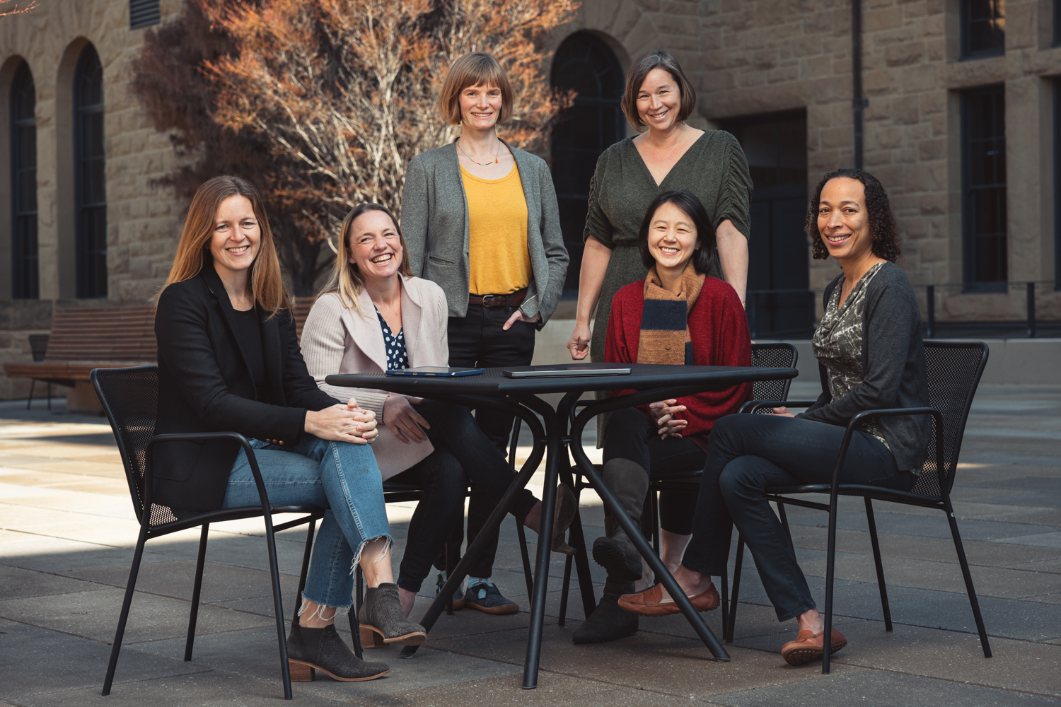 L-R around a table: Erin Mordecai, Alia Crum, Lauren Tompkins, Jessica Feldman (standing), Hyowon Gweon, and Monika Schleier-Smith