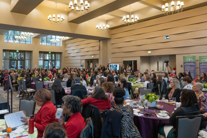 Attendees focus on speaker presentations at the Women's Leadership Summit.)