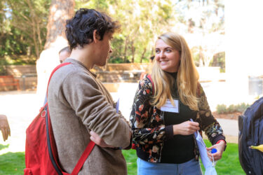 Two attendees talking outdoors.