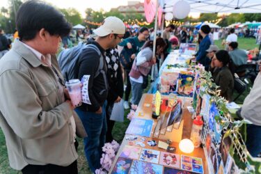 Students browsing booths filled with crafts to buy.