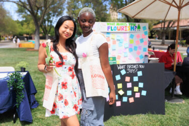 Two students with tote bags.