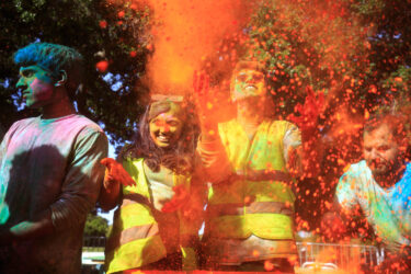 Student throwing red colored dust.