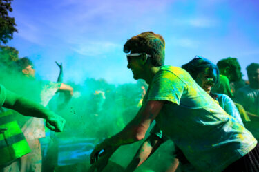 Student throwing colored dust.