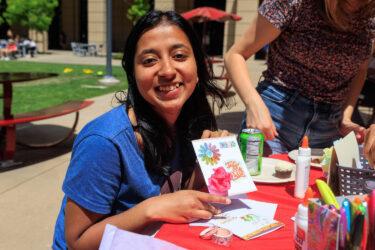 Student holding a hand-made card.