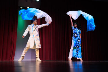 Two models unfurl blue banners.