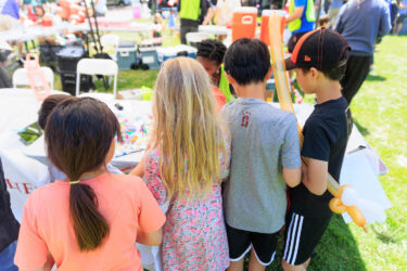 Children gathered at an arts and crafts table.