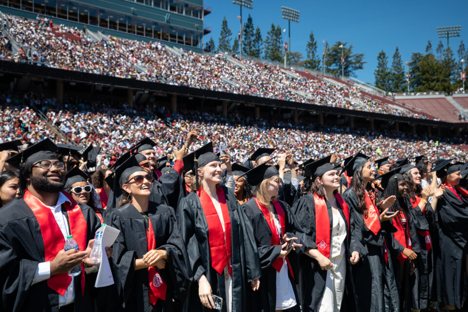 Graduates in foreground with stadium crowd in background, Stanford Commencement June 18, 2023