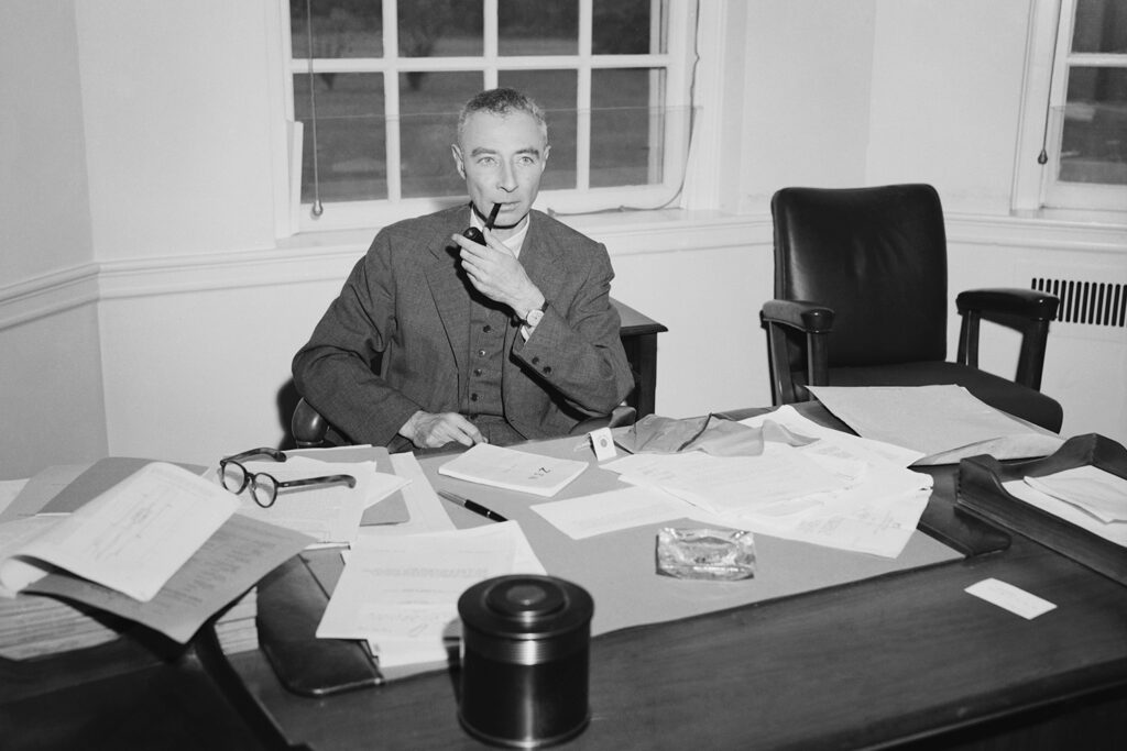 Dr. J. Robert Oppenheimer, suspended Atomic Energy Commission consultant, smokes at his desk at the Princeton Institute for Advanced Study, June 2, 1964