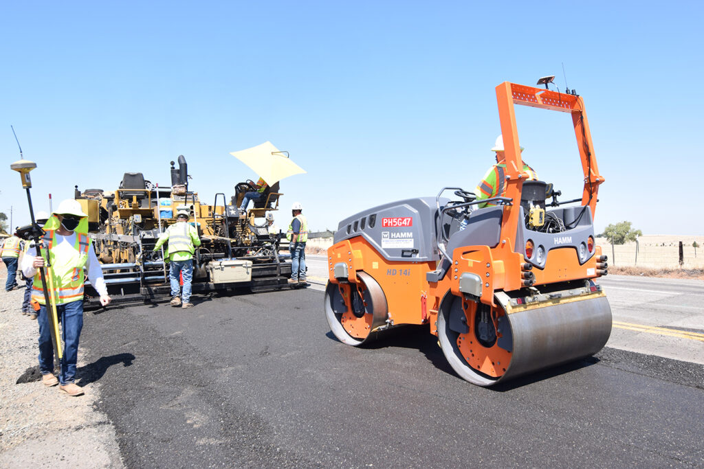 Workers pave a road.