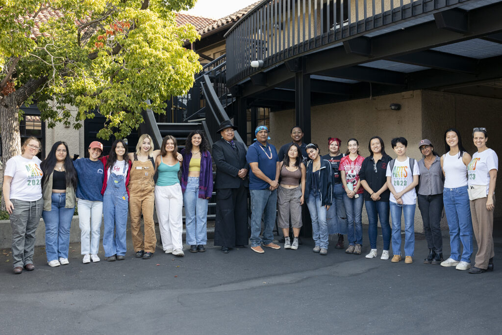 Artists Robert Blackhat Jr. and Zefren Anderson pose for a photo with Arts Intensive students and instructors during their two-day visit in September 2023.