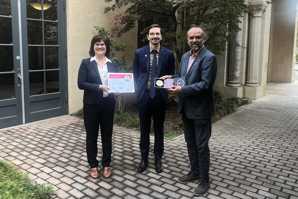 Grant Parker and Katherine Kuhns of Stanford Global Studies receive Century Medal from James King, director of the Institute of International Education Scholar Rescue Fund (IIE-SRF), on Nov. 16, 2023.