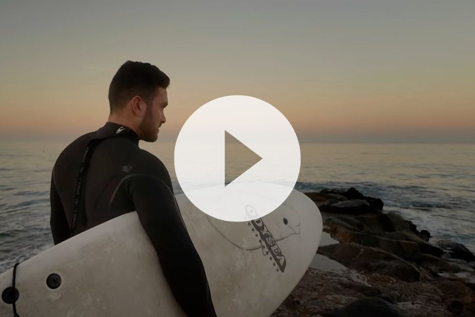 Christopher Lopez prepares to go surfing