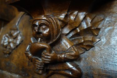 A winged musician plays the bagpipies in this misericord in All Souls College Chapel at Oxford University.