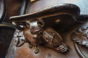 This carving of a cat playing the fiddle is located in Wells Cathedral in Wells, Somerset, England.