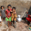 Woman and children at water standpipe in Dhaka, Bangladesh / Amy Pickering