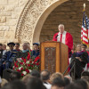 University President John Hennessy at lectern, with faculty on stage, at Stanford's 125th Opening Convocation / L.A. Cicero