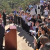 People being sworn in as U.S. citizens in an outdoor amphitheater / National Park Service