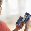 Woman reading nutritional label on a can /Photo: tmcphotos, Shutterstock