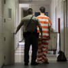 prisoner and guard walking down corridor / Rich Pedroncelli/AP Photo