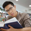 student studying a textbook / Dean Drobot/Shutterstock