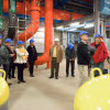 Members of the Faculty Senate in hard hats walking through the facility